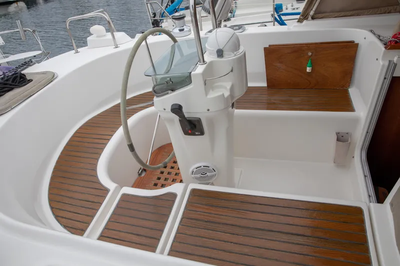 Slide: The Image of Cockpit of 1999 Beneteau Oceanis 36 CC with wooden flooring and steering wheel. - 11