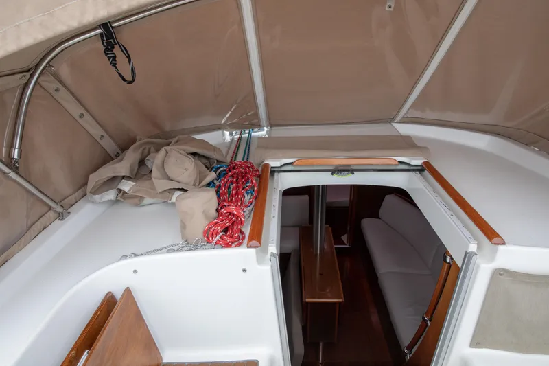 Slide: The Image of Interior view of a 1999 Beneteau Oceanis 36 CC sailboat with ropes and seating area. - 12