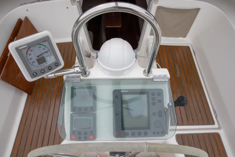 Slide: The Image of Cockpit of 1999 Beneteau Oceanis 36 CC with navigation instruments and teak flooring. - 13