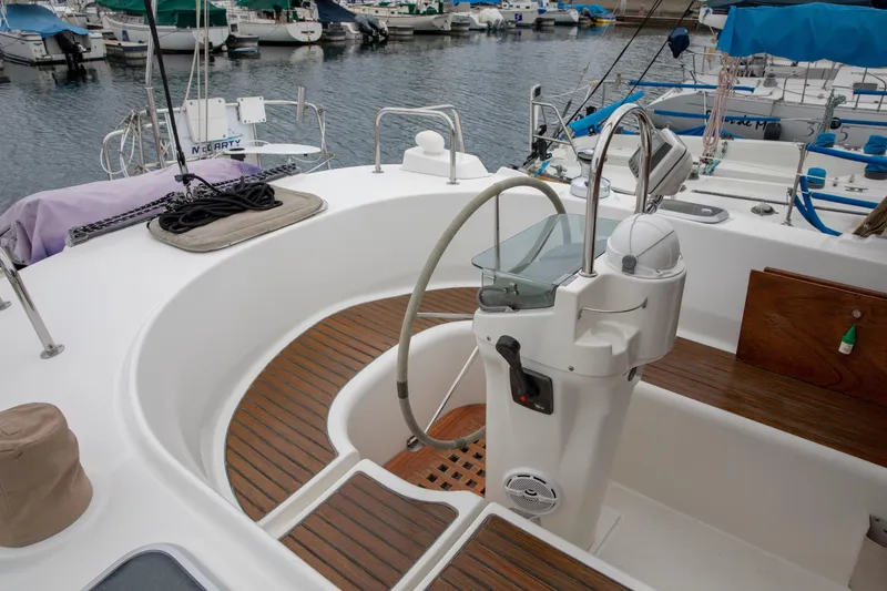Slide: The Image of Cockpit of 1999 Beneteau Oceanis 36 CC sailboat with wooden flooring and steering wheel. - 14