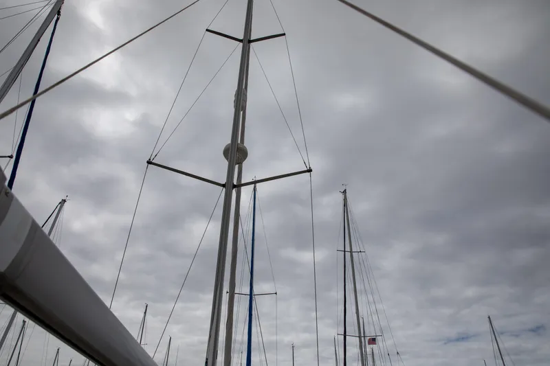 Slide: The Image of Masts of a 1999 Beneteau Oceanis 36 CC sailboat against a cloudy sky. - 18