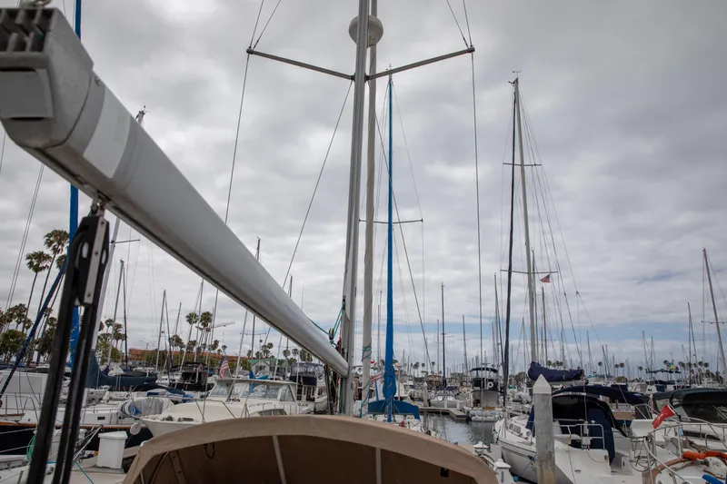 Slide: The Image of 1999 Beneteau Oceanis 36 CC sailboat docked in a marina under cloudy skies. - 19