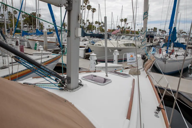 Slide: The Image of 1999 Beneteau Oceanis 36 CC sailboat docked in a marina with other boats. - 21