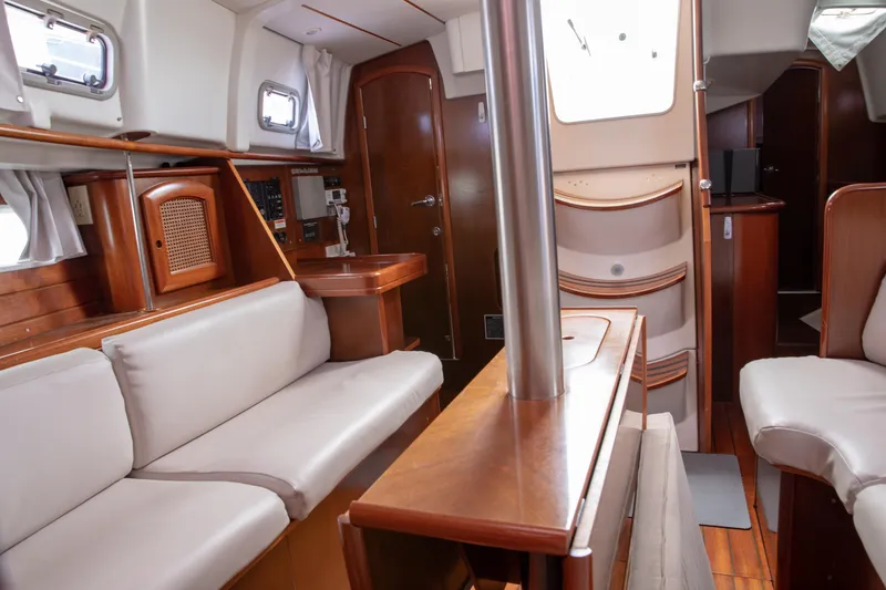Slide: The Image of Interior of 1999 Beneteau Oceanis 36 CC sailboat with wood finish and seating area. - 23