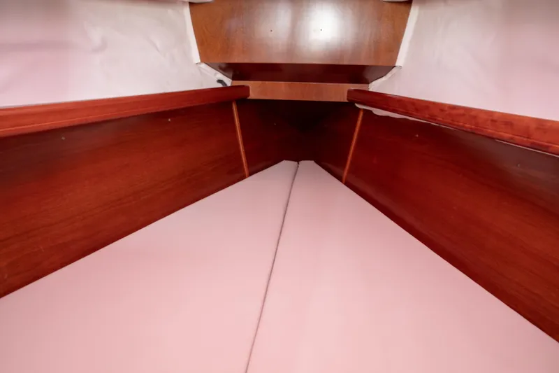 Slide: The Image of Interior cabin of 1999 Beneteau Oceanis 36 CC sailboat with wooden finish and cozy bedding. - 26