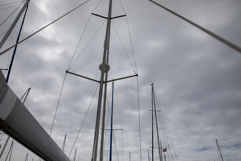 Slide: The Image of Masts of a 1999 Beneteau Oceanis 36 CC sailboat against a cloudy sky. - 27