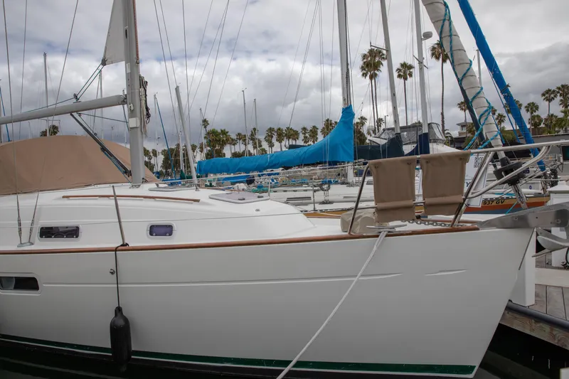 Slide: The Image of 1999 Beneteau Oceanis 36 CC sailboat docked in marina, surrounded by other vessels. - 3