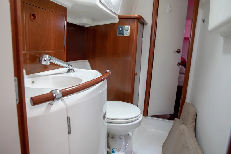 Slide: The Image of Bathroom interior of 1999 Beneteau Oceanis 36 CC yacht, featuring sink and toilet. - 31