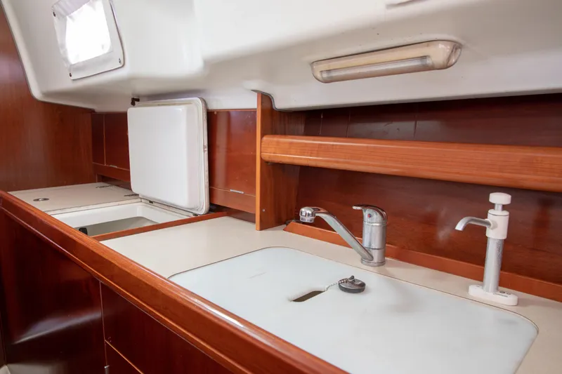 Slide: The Image of Interior view of 1999 Beneteau Oceanis 36 CC yacht kitchen with sink and wooden cabinetry. - 34