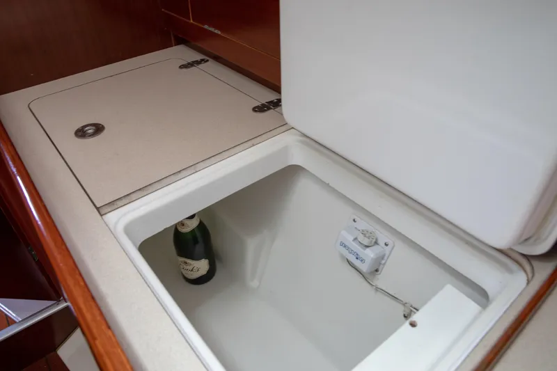 Slide: The Image of Beneteau Oceanis 36 CC 1999 yacht interior with open cooler and champagne bottle. - 35