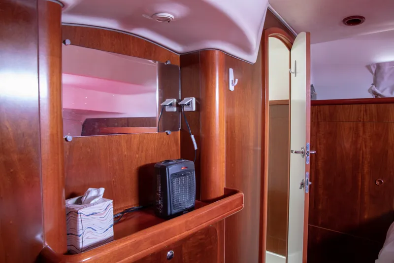 Slide: The Image of Interior of 1999 Beneteau Oceanis 36 CC yacht with wooden cabinetry and modern amenities. - 36