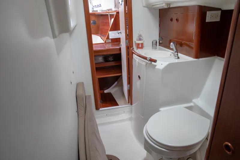 Slide: The Image of Bathroom interior of 1999 Beneteau Oceanis 36 CC yacht, featuring sink and toilet. - 38