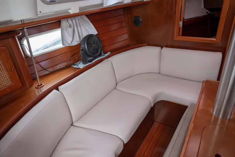 Slide: The Image of Interior of 1999 Beneteau Oceanis 36 CC sailboat with white cushioned seating. - 41