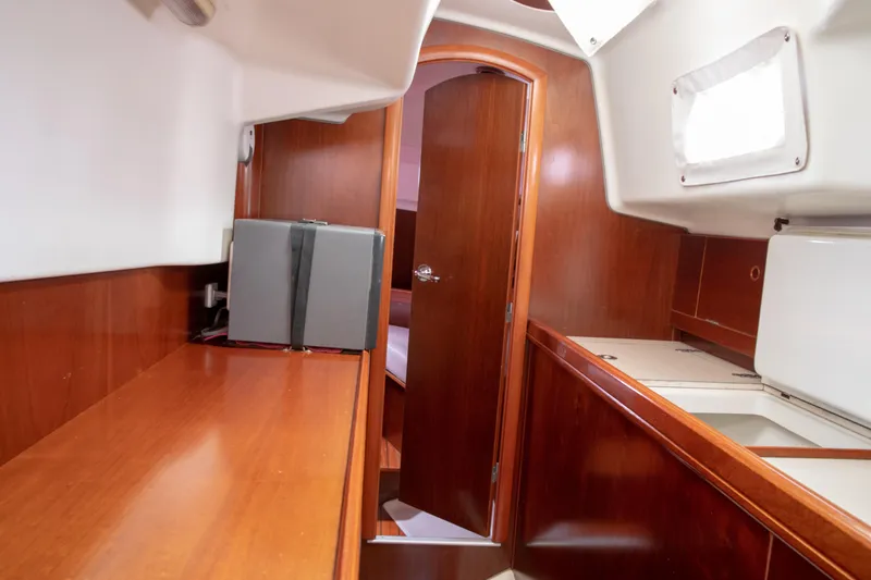 Slide: The Image of Interior of 1999 Beneteau Oceanis 36 CC sailboat with wooden cabinetry and compact design. - 42
