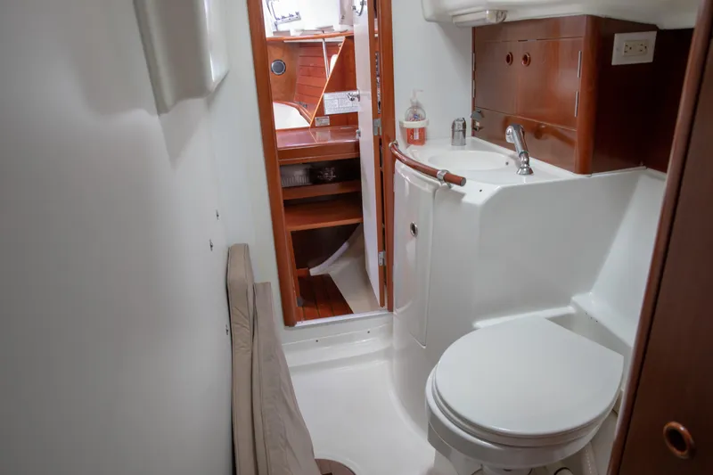 Slide: The Image of Bathroom interior of 1999 Beneteau Oceanis 36 CC yacht, featuring sink and toilet. - 45