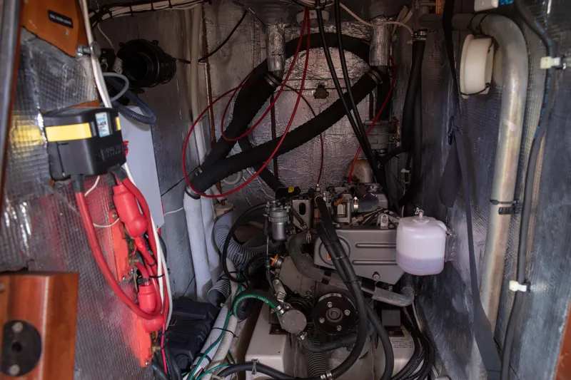 Slide: The Image of Engine room of a 1999 Beneteau Oceanis 36 CC sailboat, showcasing mechanical components. - 48