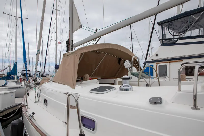Slide: The Image of 1999 Beneteau Oceanis 36 CC sailboat docked in a marina, featuring a beige canopy. - 5