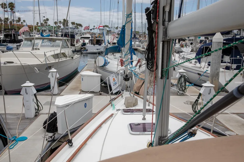 Slide: The Image of 1999 Beneteau Oceanis 36 CC sailboat docked in a busy marina with other boats. - 50