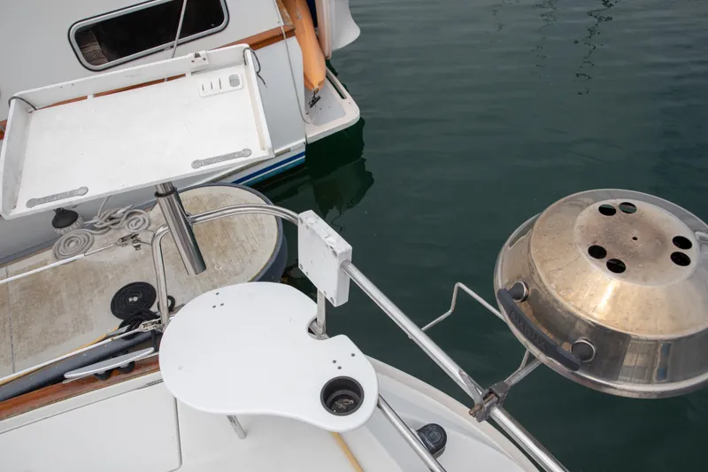 Slide: The Image of Deck view of a 1999 Beneteau Oceanis 36 CC with grill and table setup. - 58