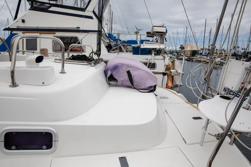 Slide: The Image of Beneteau Oceanis 36 CC sailboat deck, 1999 model, docked in a marina with other boats. - 6