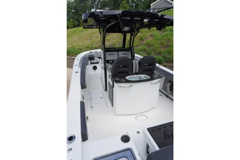 Slide: The Image of 2025 Sea Pro 292 DLX boat interior with seating and control panel. - 11