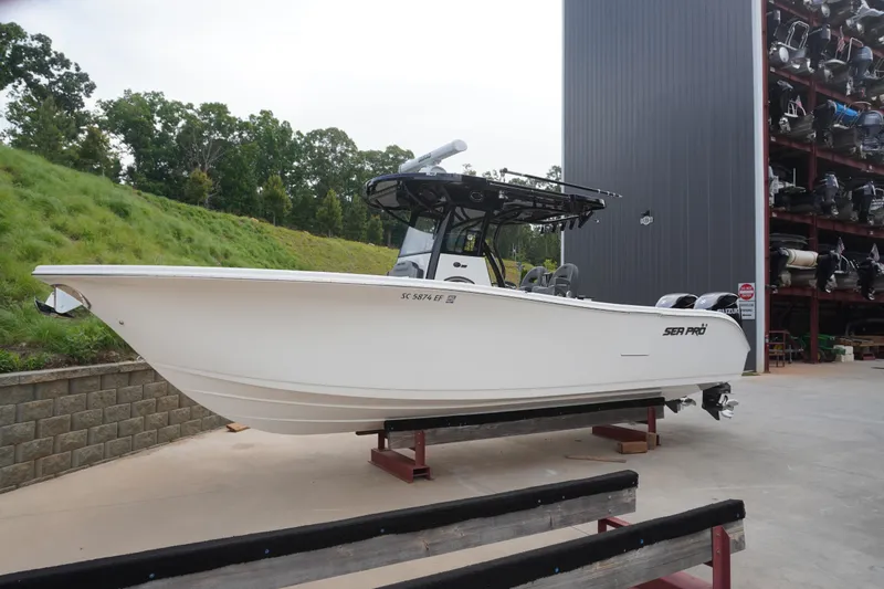 The Image of 2025 Sea Pro 292 DLX boat on display in a storage facility. - 2