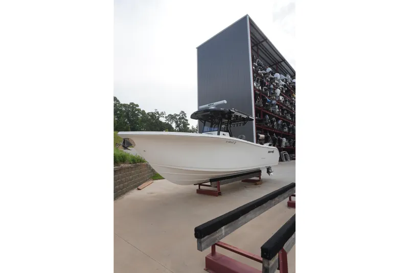 Slide: The Image of 2025 Sea Pro 292 DLX boat on display at a marina storage facility. - 3