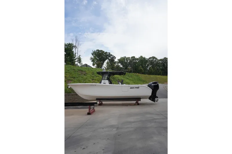 Slide: The Image of 2025 Sea Pro 292 DLX boat on display outdoors, side view. - 4