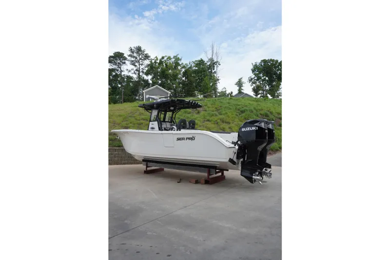Slide: The Image of 2025 Sea Pro 292 DLX boat with Suzuki outboard engines on display outdoors. - 5
