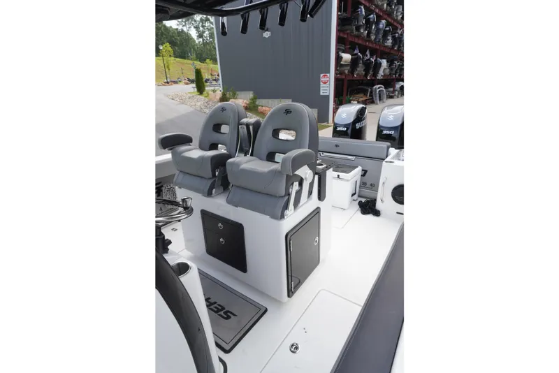 Slide: The Image of 2025 Sea Pro 292 DLX boat interior with dual gray captain seats and storage compartments. - 7