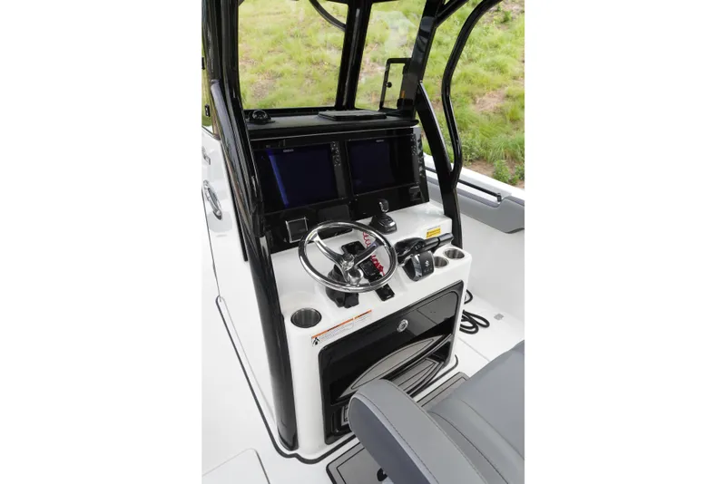 Slide: The Image of 2025 Sea Pro 292 DLX boat helm with modern controls and dual screens. - 8