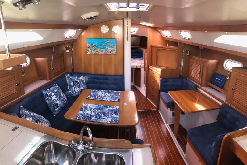 Slide: The Image of Interior of 2000 Catalina 36 MkII sailboat with cozy seating and wooden finishes. - 1