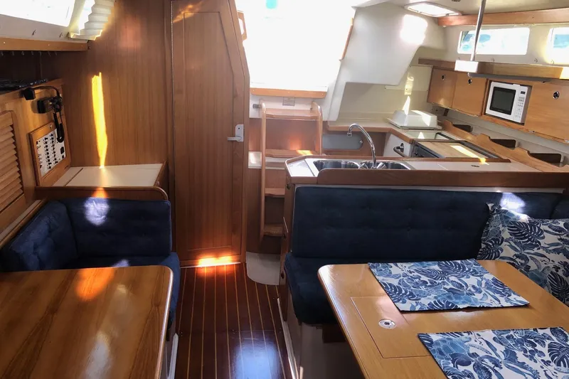 Slide: The Image of Interior of 2000 Catalina 36 MkII sailboat with wood finish and cozy seating area. - 10