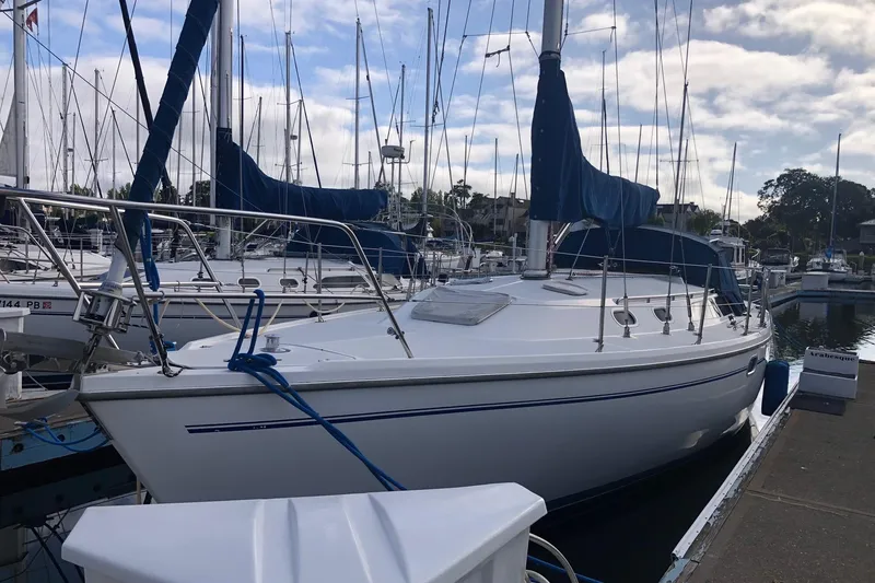 Slide: The Image of 2000 Catalina 36 MkII sailboat docked at marina under cloudy sky. - 11