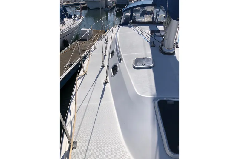 Slide: The Image of 2000 Catalina 36 MkII sailboat deck with railing and hatch, docked at marina. - 16