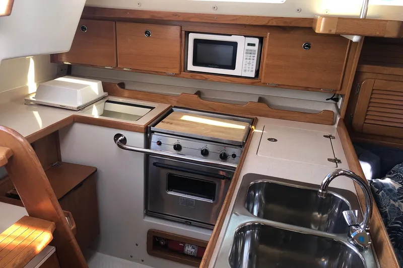 Slide: The Image of Galley kitchen in 2000 Catalina 36 MkII sailboat with stove, microwave, and double sink. - 5