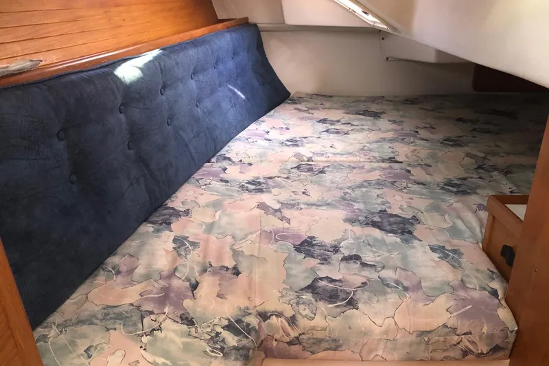 Slide: The Image of Cozy cabin interior of 2000 Catalina 36 MkII sailboat with patterned bedding. - 9