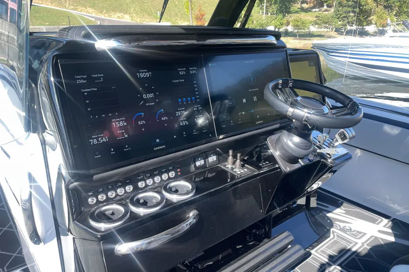 Slide: The Image of 2025 Nor-Tech 450 Sport Center Console dashboard with advanced digital displays and controls. - 28