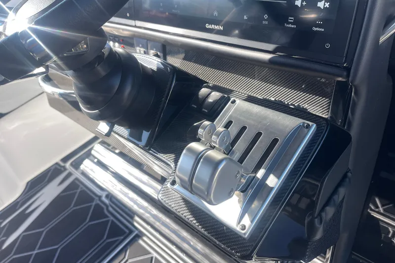 Slide: The Image of 2025 Nor-Tech 450 Sport Center Console helm with advanced controls and Garmin display. - 30