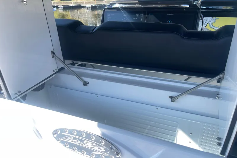 Slide: The Image of 2025 Nor-Tech 450 Sport Center Console storage compartment with open hatch, showcasing interior design. - 31