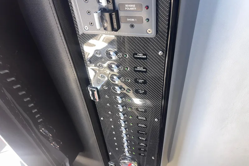 Slide: The Image of Control panel of 2025 Nor-Tech 450 Sport Center Console with various switches and indicators. - 40