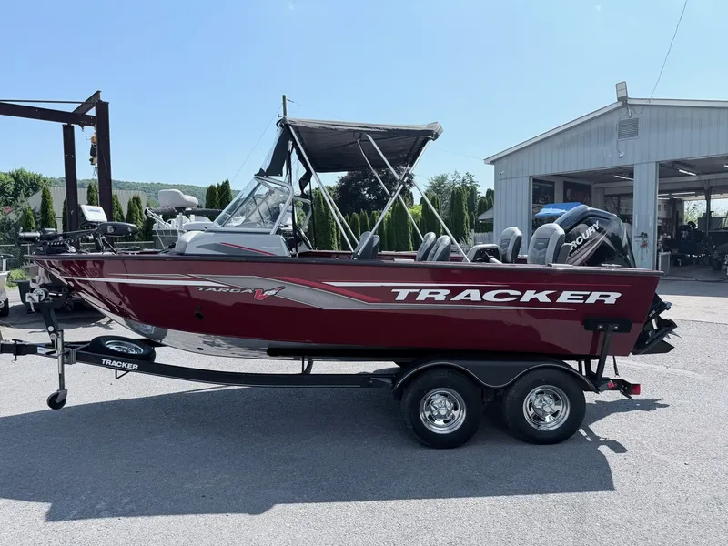 Slide: The Image of 2017 Tracker Targa V-18 Combo boat on trailer outside workshop. - 11
