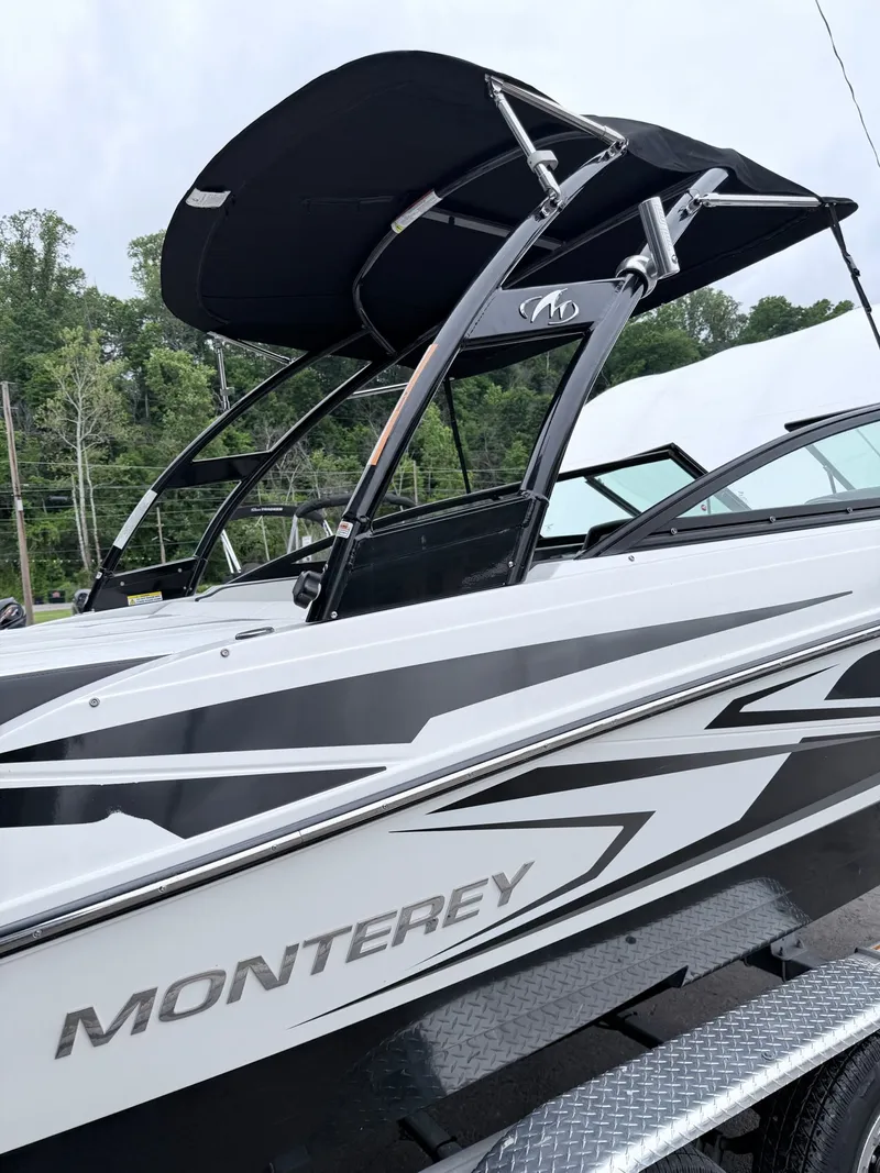 Slide: The Image of 2020 Monterey M-20 boat with black canopy and sleek design. - 32