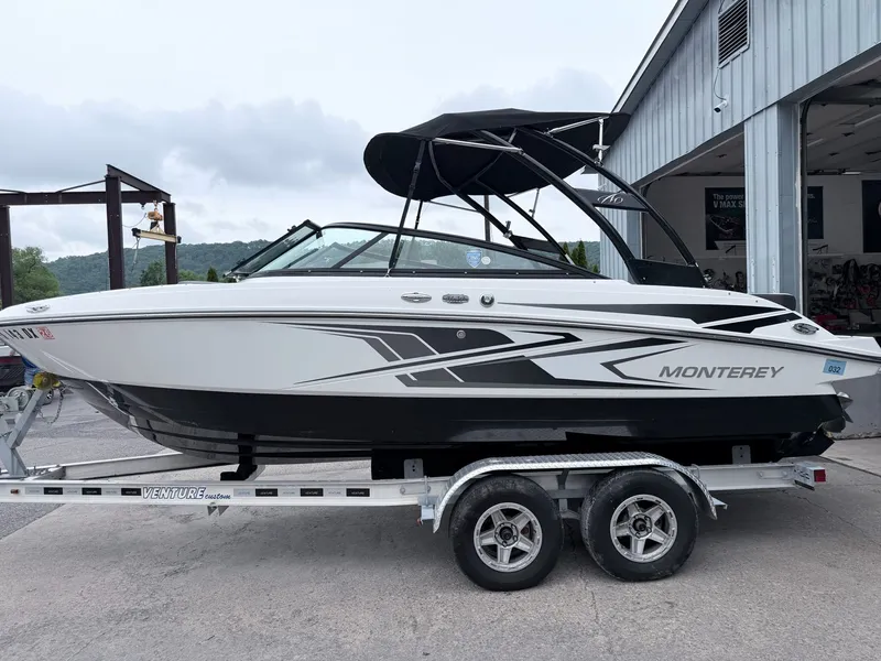 Slide: The Image of 2020 Monterey M-20 boat on trailer outside garage. - 40