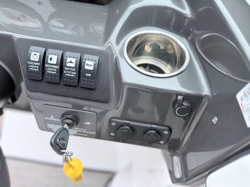Slide: The Image of Dashboard of a 2020 Monterey M-20 boat with switches and cup holder. - 8