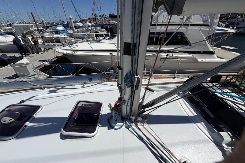 Slide: The Image of Beneteau Oceanis 37 sailboat deck, 2010 model, docked in a marina with other boats. - 10