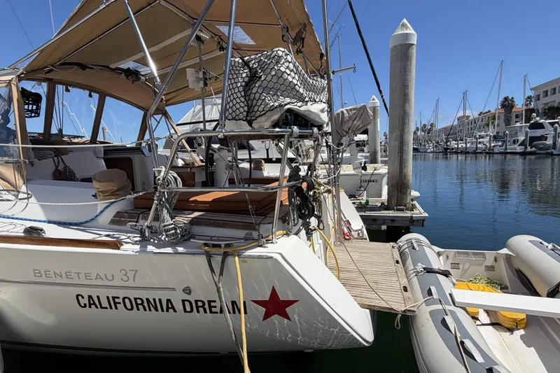 Slide: The Image of Beneteau Oceanis 37 sailboat docked in marina, named "California Dream," year 2010. - 15