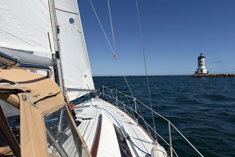 Slide: The Image of Sailing Beneteau Oceanis 37 near lighthouse on clear day, 2010 model. - 16