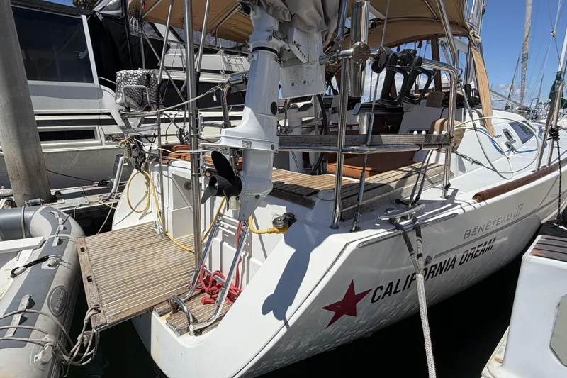 Slide: The Image of 2010 Beneteau Oceanis 37 sailboat docked, featuring a spacious deck and modern design. - 17