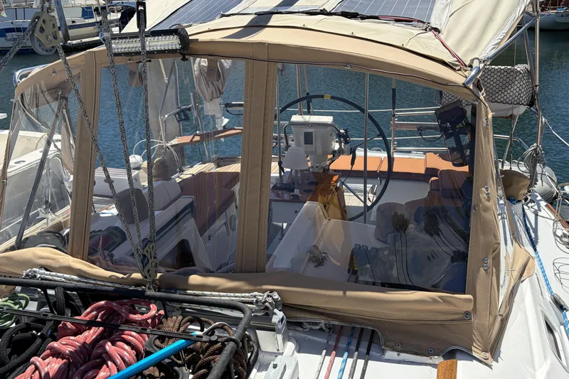 Slide: The Image of Cockpit of a 2010 Beneteau Oceanis 37 sailboat with protective canopy and steering wheel. - 18